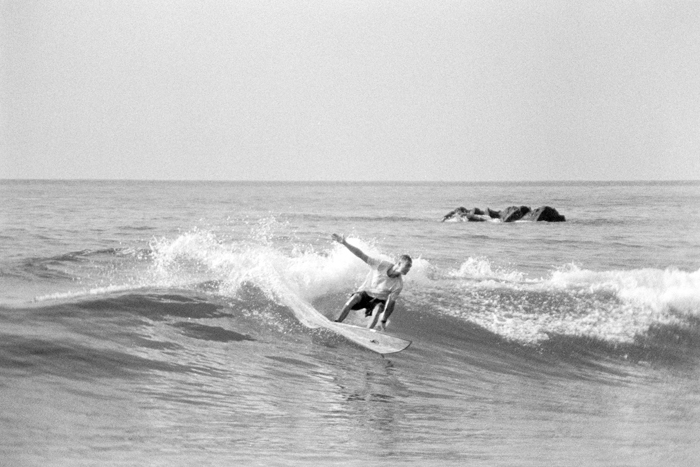 Alt-Text: Surfer riding a right-hander at La Fortuna on the East Cape, shot on black and white film